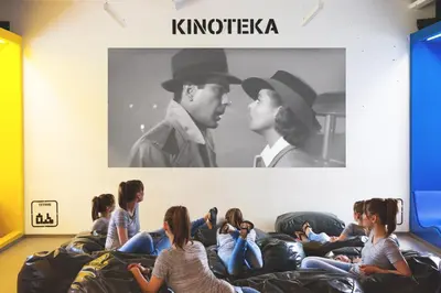 a group of people sitting on chairs in a room at Youth Hostel Proteus Postojna in Postojna