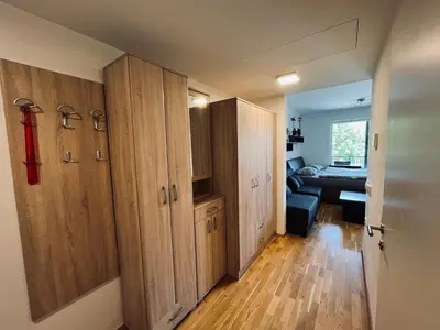 a room with wooden cabinets and a living room at Vitan Apartment in Bled