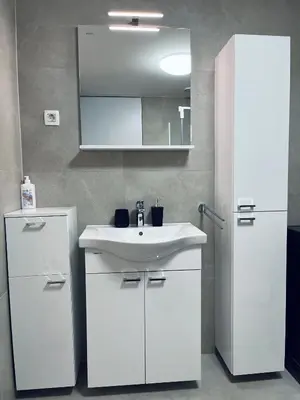 a white bathroom with a sink and a mirror at Vitan Apartment in Bled