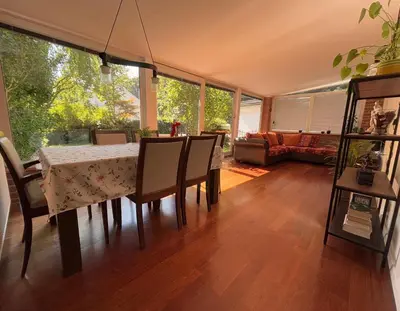 a dining room with a table and chairs and a couch at The Green City Apartment in Ljubljana