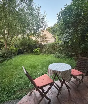 two chairs and a table on a patio at The Green City Apartment in Ljubljana