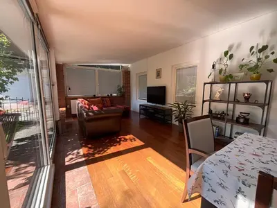 a living room with a couch and a table at The Green City Apartment in Ljubljana