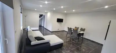 a living room with a couch and a table at Apartma Viković