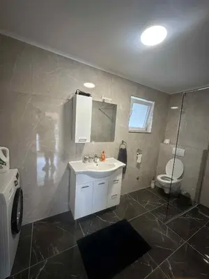 a bathroom with a sink and a toilet at Apartma Viković