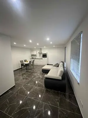 a living room with a couch and a table at Apartma Viković