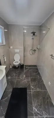 a bathroom with a shower with a toilet and a sink at Apartma Viković