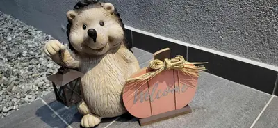 a teddy bear sitting on a sidewalk next to a bag at Apartma Viković