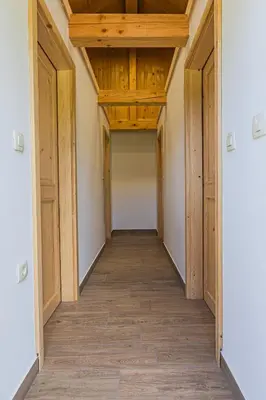 an empty hallway with wooden ceilings and wood floors at Glamping Radovna pr' Klemenak in Zgornje Gorje