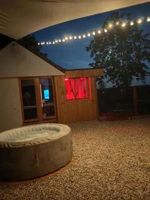 a building with a large round bed in a yard at night at Casa33 in Dobrovnik