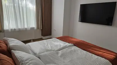 a living room with a couch and a flat screen tv at Memento Ljubljana Apartments with Private Bathrooms & Shared Kitchen in Ljubljana