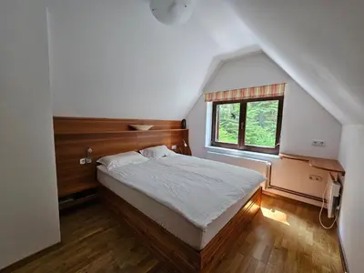 a bedroom with a bed and a window at Chalet 61 Lake Jasna in Kranjska Gora