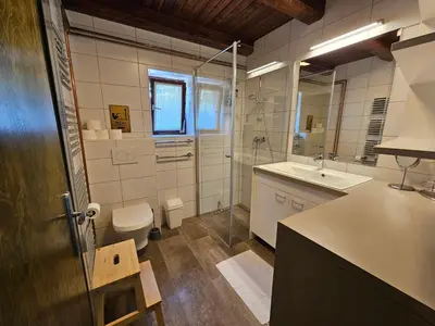 a bathroom with a sink and a toilet and a mirror at Chalet 61 Lake Jasna in Kranjska Gora