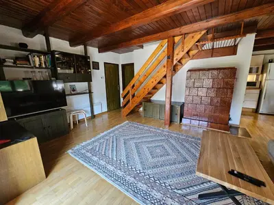 a living room with a rug on a wooden floor at Chalet 61 Lake Jasna in Kranjska Gora