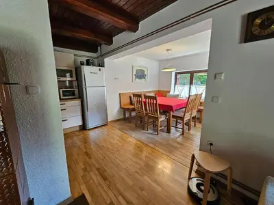a kitchen and dining room with a red table and chairs at Chalet 61 Lake Jasna in Kranjska Gora