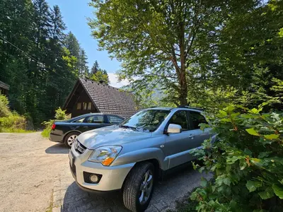 a blue and white truck parked in front of a house at Chalet 61 Lake Jasna in Kranjska Gora