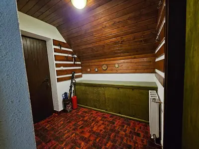 a sauna with a wooden wall and a door at Chalet 61 Lake Jasna in Kranjska Gora