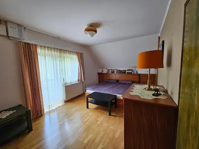 a bedroom with a bed and a desk with a lamp at Chalet 61 Lake Jasna in Kranjska Gora