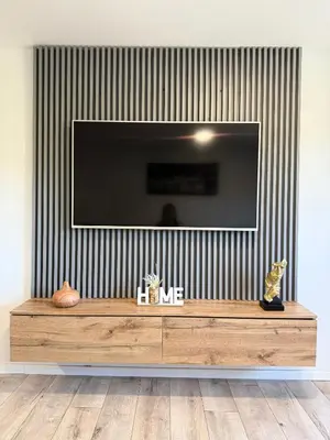 a living room with a television on a wall at ART Nature Retreat in Gorica pri Slivnici