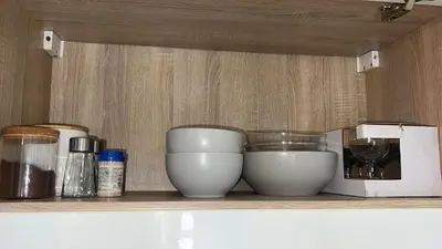 a shelf with two white bowls and a blender at CC Vič in Ljubljana