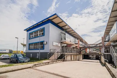 a blue and white building with a car parked in front at Comfort Rooms Obrežje by Highway, Free Covered Parking in Jesenice na Dolenjskem