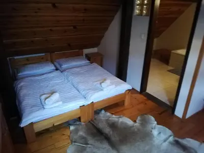 a bed with two pillows on it in a room at Guest House Turistična kmetija Plaznik in Ljubno