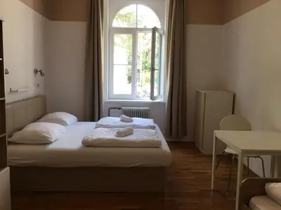 a bedroom with two beds and a window at C - Punkt Hostel in Ljubljana