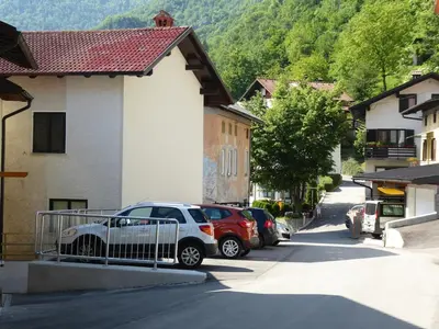 a car parked in a parking lot next to a building at Hiša Nad Reko Baca in Most na Soči
