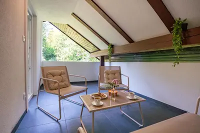 two chairs and a table in a room at Apartments Lian in Bled