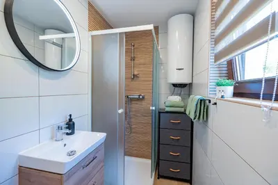 a bathroom with a sink and a mirror at Apartments Lian in Bled