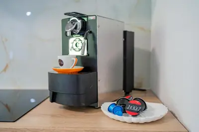 a coffee machine with a cup on a table at Apartments Lian in Bled