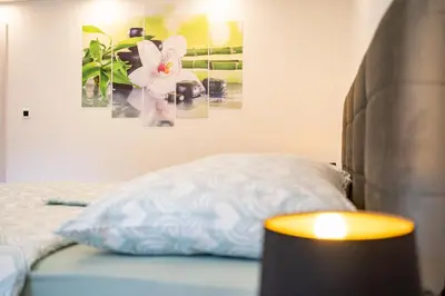 a bedroom with a bed with a pillow and a lamp at Apartments Lian in Bled