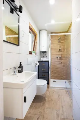 a bathroom with a sink and a toilet and a shower at Apartments Lian in Bled