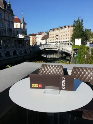a coffee table with a couch and a bridge at Cacao Rooms in Ljubljana