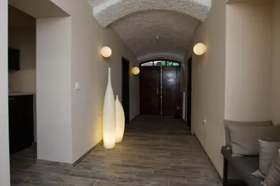 a hallway of a house with a door and a tile floor at Cacao Rooms in Ljubljana