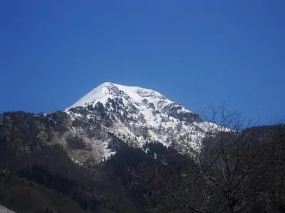 a snow covered mountain with a blue sky at Farm Pri Flandru in Cerkno