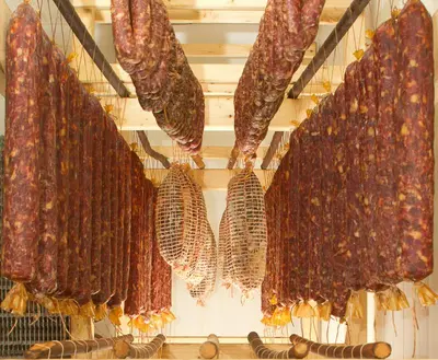 a bunch of food hanging on a rack in a store at Farm Pri Flandru in Cerkno