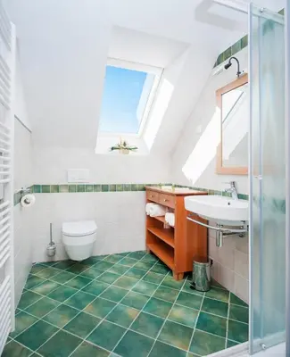 a bathroom with a sink and a toilet and a window at Gostilna in picerija Harlekin in Ribnica