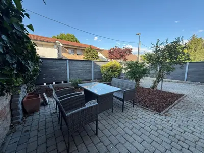 a patio with a table and chairs and a fence at City Nest Ljubljana - Terrace & Free Parking in Ljubljana