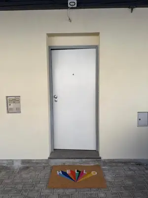 a door with a rug in front of it with a door sidx sidx at City Nest Ljubljana - Terrace & Free Parking in Ljubljana