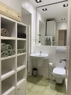 a white bathroom with a sink and a toilet at City Nest Ljubljana - Terrace & Free Parking in Ljubljana