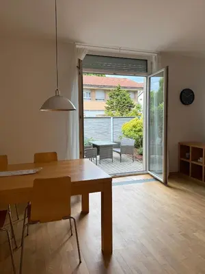 a dining room with a table and a sliding glass door at City Nest Ljubljana - Terrace & Free Parking in Ljubljana