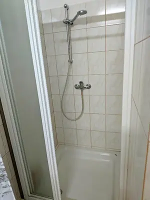 a shower with a hose in a bathroom at Soba Amaris bianco in Benedikt v Slovenskih Goricah