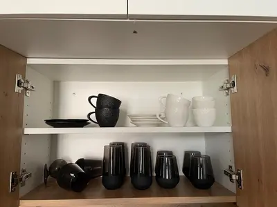 a cupboard with a bunch of pots and pans at Mirno in elegantno stanovanje - Parkirišče, Netflix, wifi in Maribor