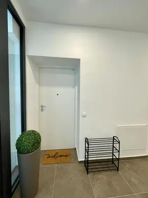 a empty hallway with a bench next to a door at Mirno in elegantno stanovanje - Parkirišče, Netflix, wifi in Maribor