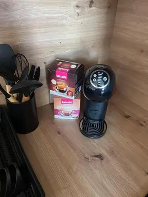 a coffee maker sitting on a table next to a box at Mirno in elegantno stanovanje - Parkirišče, Netflix, wifi in Maribor