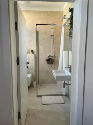a bathroom with a glass shower and a sink at Mirno in elegantno stanovanje - Parkirišče, Netflix, wifi in Maribor