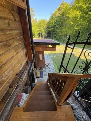 a wooden stairway leading up to a building at Glamping Medvedjek - Nočitev v vinskem sodu in Velika Loka