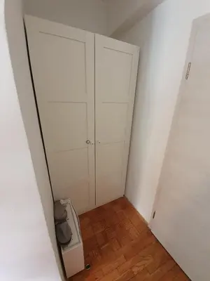 a room with two white closets and a washing machine at Sweet Vibes Studio at Šiška district, with Parking in Ljubljana