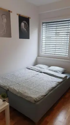 a bed in a white room with a window at Sweet Vibes Studio at Šiška district, with Parking in Ljubljana