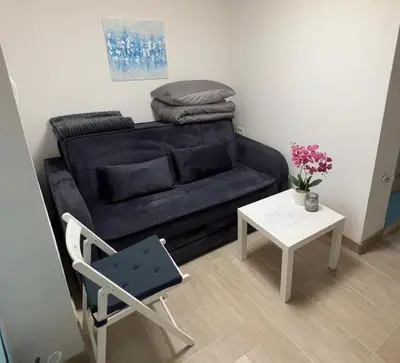 a living room with a couch and a table at Cosy Corner Vič in Ljubljana